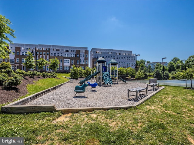 view of jungle gym with tennis court and a yard