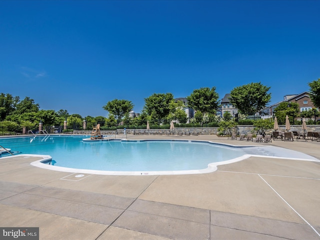 view of swimming pool featuring a patio area