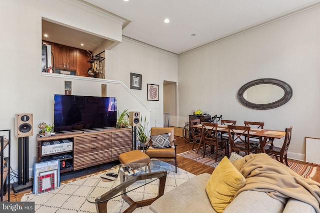 living room featuring light wood-type flooring and ornamental molding