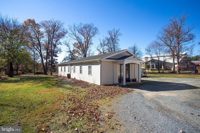 view of property exterior featuring a lawn