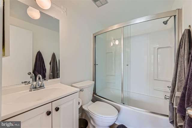 full bathroom featuring shower / bath combination with glass door, vanity, and toilet