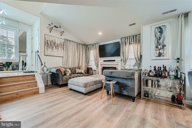 sitting room featuring light hardwood / wood-style flooring and lofted ceiling