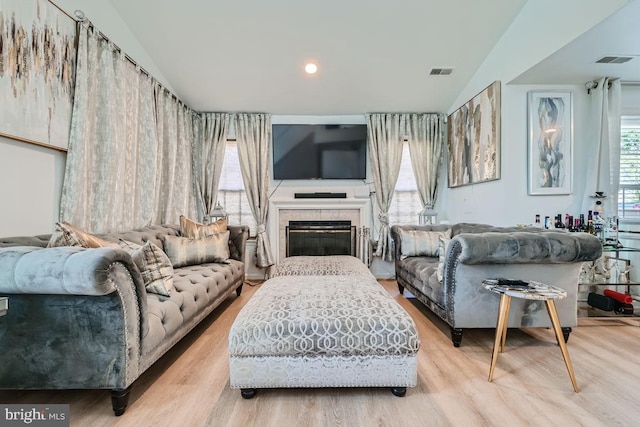 living room with a fireplace and light hardwood / wood-style flooring