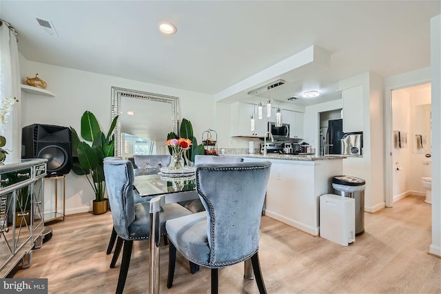 dining space featuring light hardwood / wood-style floors