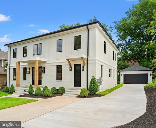 modern farmhouse style home with covered porch, a garage, and an outdoor structure