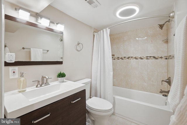 full bathroom with vanity, tile patterned floors, toilet, and shower / bath combo