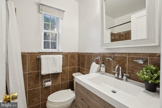 bathroom featuring vanity, tile walls, curtained shower, and toilet