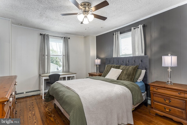 bedroom featuring a textured ceiling, ornamental molding, dark wood-style flooring, and a ceiling fan