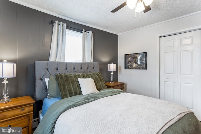 bedroom with a ceiling fan, crown molding, a textured ceiling, a baseboard heating unit, and a closet