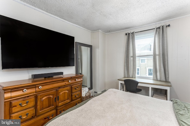 bedroom featuring baseboard heating and a textured ceiling