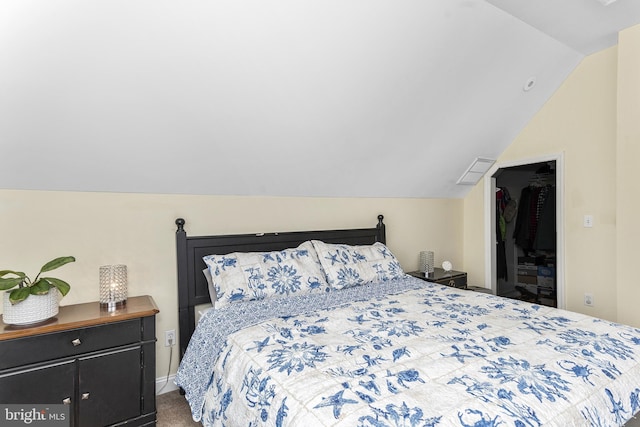 bedroom featuring vaulted ceiling and carpet flooring