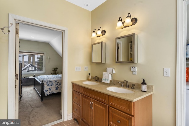 ensuite bathroom featuring vaulted ceiling, double vanity, ensuite bath, and a sink