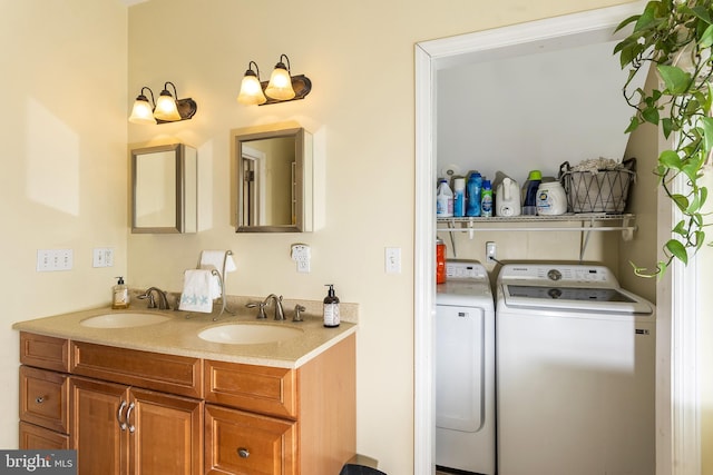 bathroom featuring a sink, washing machine and clothes dryer, and double vanity