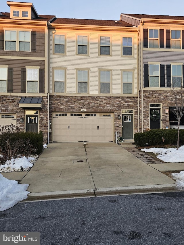 townhome / multi-family property featuring a garage