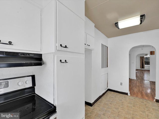 kitchen featuring white cabinetry, range hood, and electric range