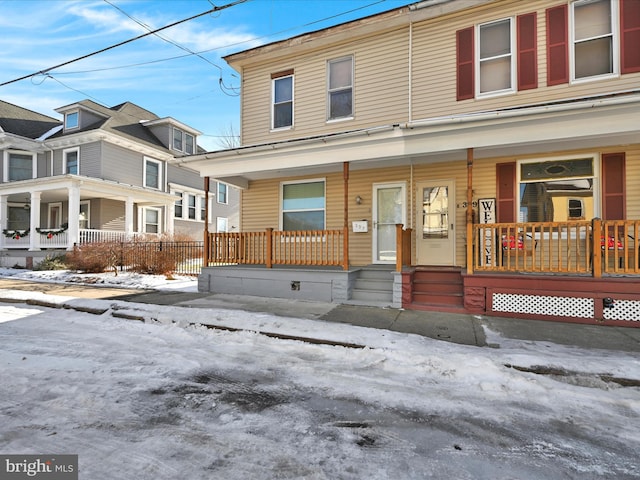 townhome / multi-family property featuring a porch