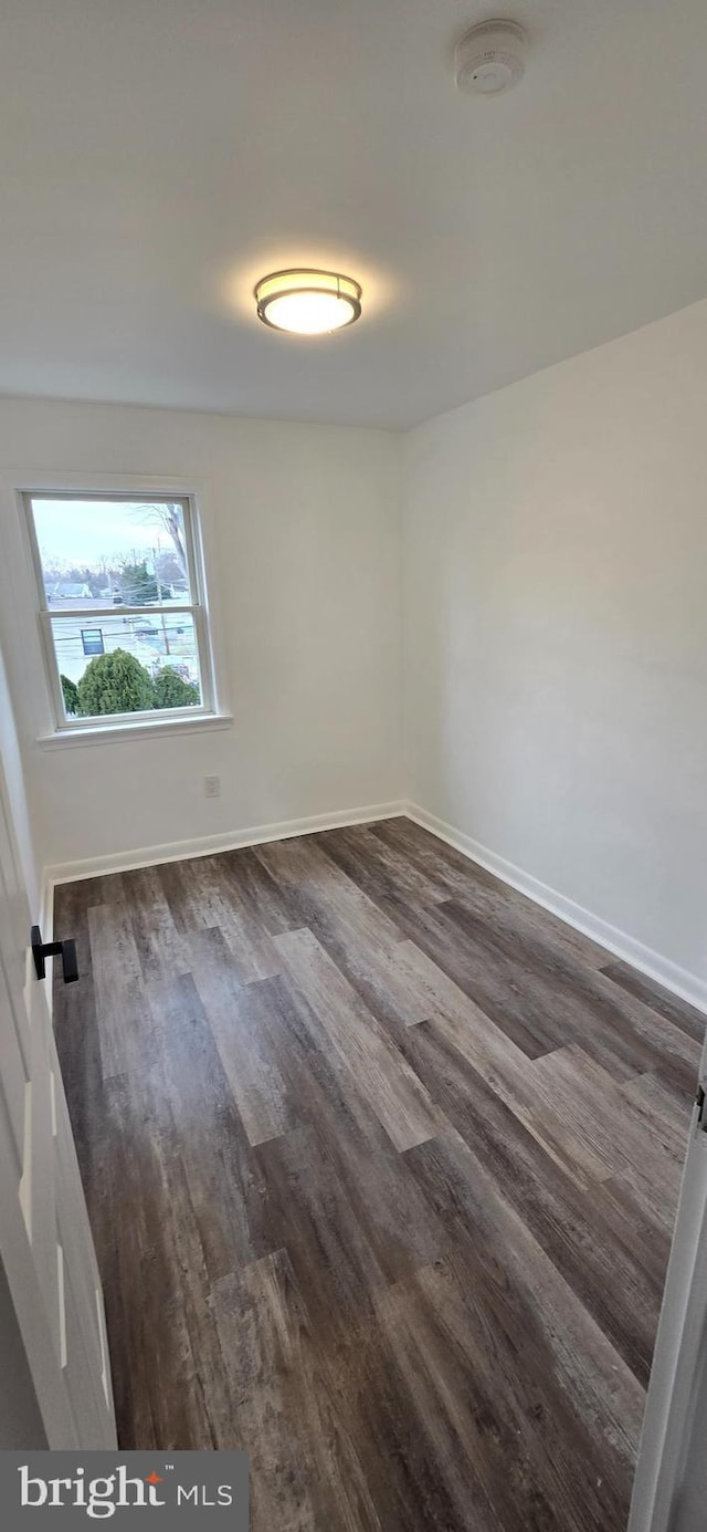 unfurnished room with dark hardwood / wood-style floors