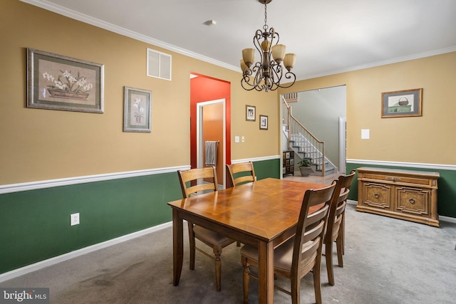 dining space with carpet floors, visible vents, ornamental molding, and stairs