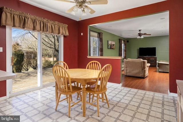 dining area with baseboards, a ceiling fan, and tile patterned floors