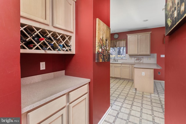 kitchen featuring a sink, light floors, and light countertops