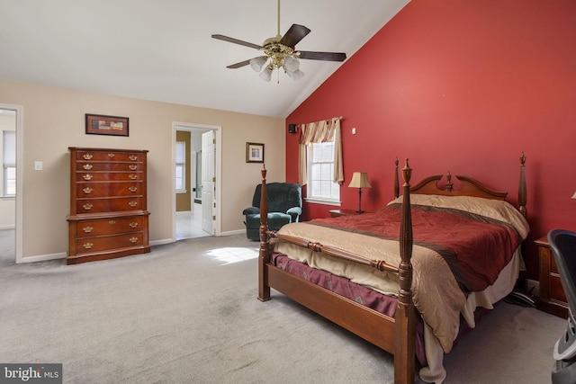 carpeted bedroom with high vaulted ceiling, connected bathroom, baseboards, and ceiling fan