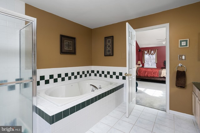 ensuite bathroom with ensuite bathroom, tile patterned flooring, vanity, a tile shower, and a bath