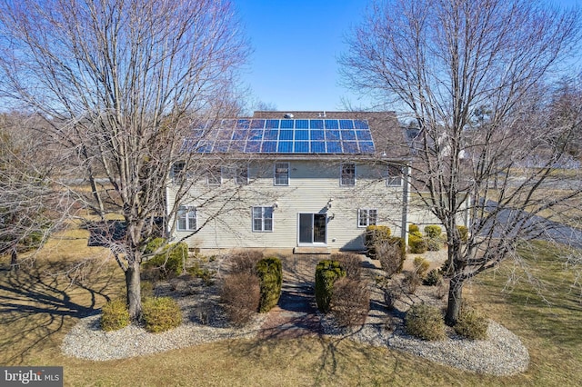 view of side of property featuring solar panels