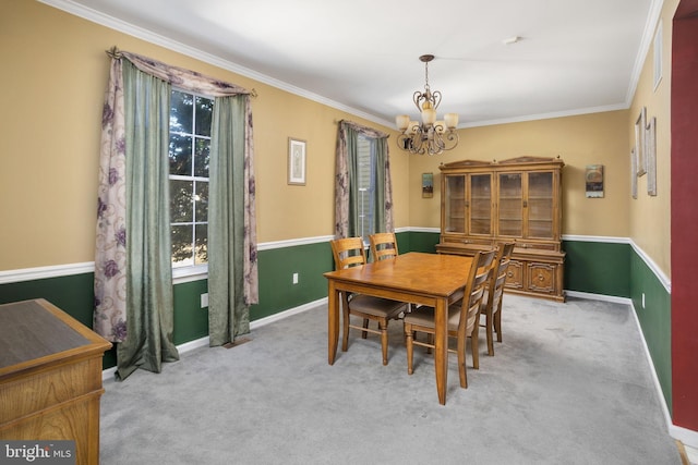 carpeted dining area featuring a chandelier, ornamental molding, and baseboards