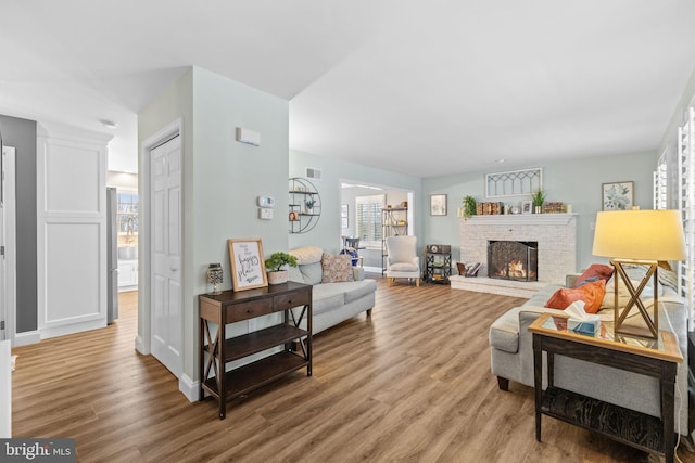 living room featuring hardwood / wood-style flooring and a fireplace