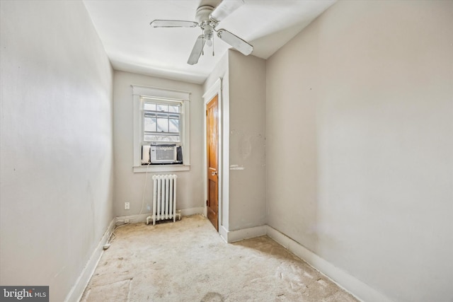 carpeted empty room featuring cooling unit, ceiling fan, and radiator