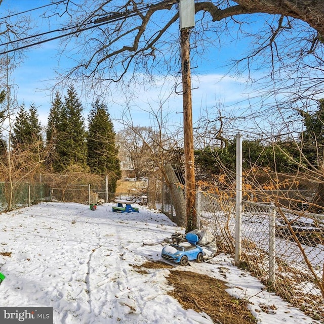 view of yard layered in snow