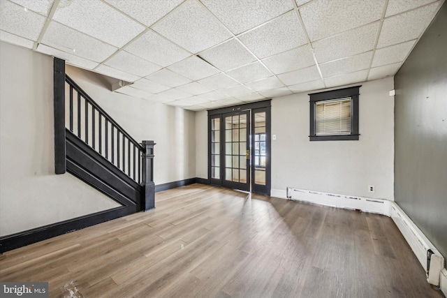 spare room with hardwood / wood-style flooring and a drop ceiling