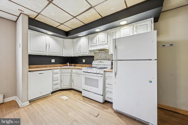 kitchen featuring sink, white cabinets, white appliances, and light hardwood / wood-style floors