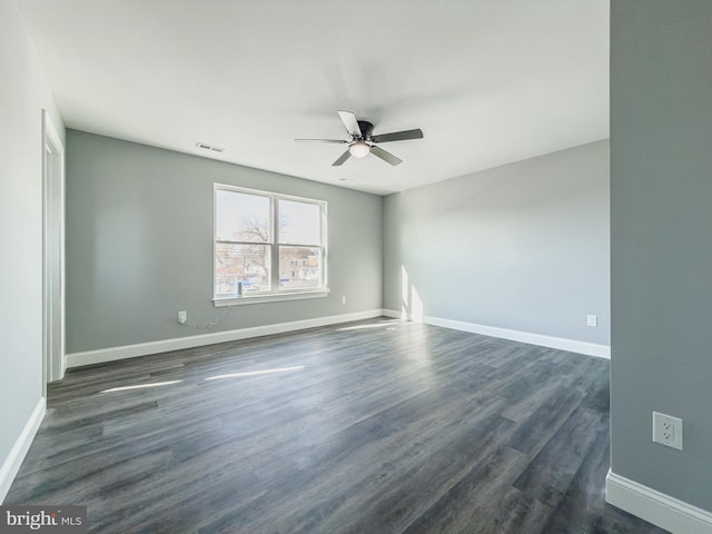 spare room with dark hardwood / wood-style floors and ceiling fan