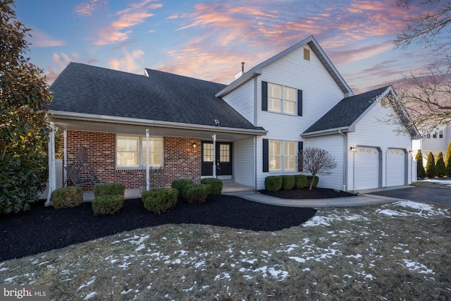 front of property featuring a garage and covered porch