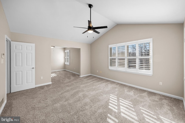 unfurnished bedroom featuring ceiling fan, vaulted ceiling, and light colored carpet