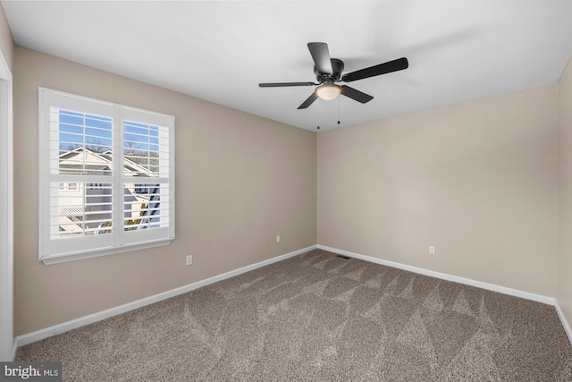 carpeted empty room featuring ceiling fan