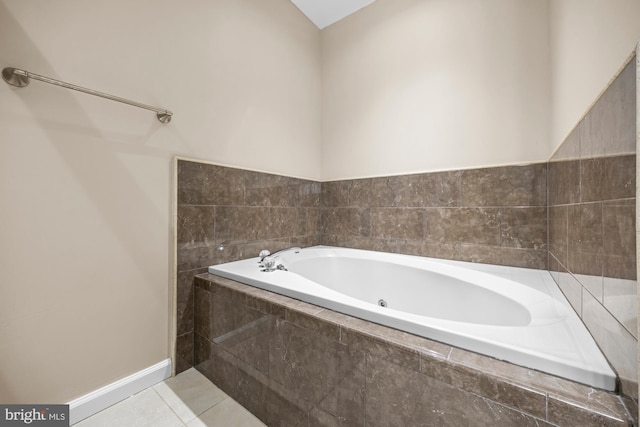 bathroom with tile patterned flooring and tiled bath