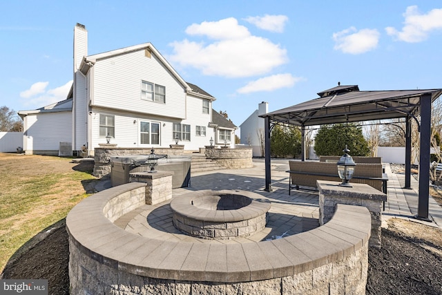 view of patio / terrace featuring an outdoor living space with a fire pit, cooling unit, and a gazebo