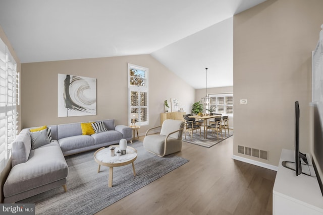 living room featuring hardwood / wood-style floors and vaulted ceiling