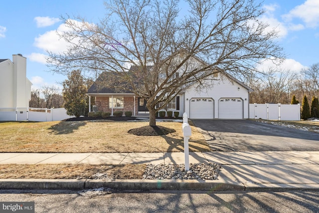 view of front of property featuring a front yard and a garage