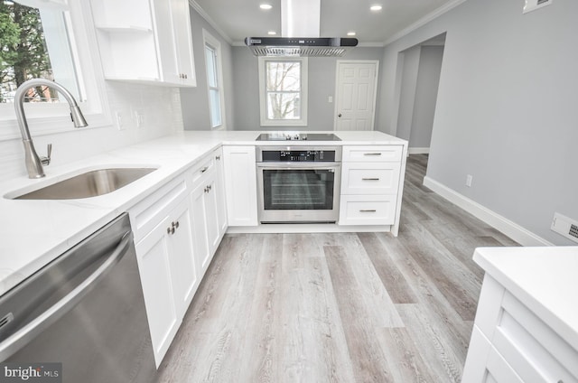 kitchen with sink, stainless steel appliances, light hardwood / wood-style flooring, white cabinets, and exhaust hood