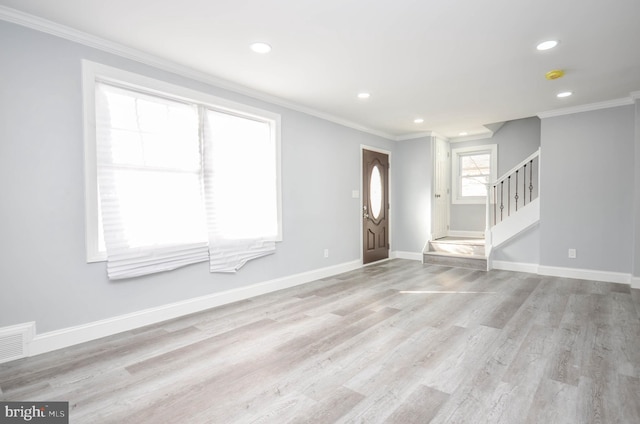 interior space with light hardwood / wood-style flooring and ornamental molding