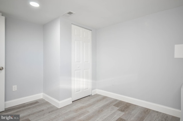 unfurnished bedroom with light hardwood / wood-style floors and a closet