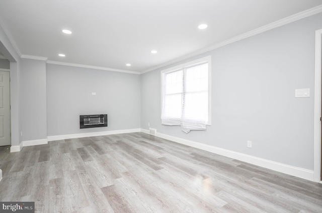 unfurnished living room featuring light hardwood / wood-style floors, crown molding, and heating unit