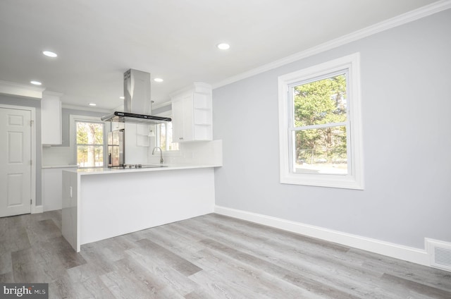 kitchen with white cabinetry, decorative backsplash, stainless steel fridge with ice dispenser, kitchen peninsula, and island range hood