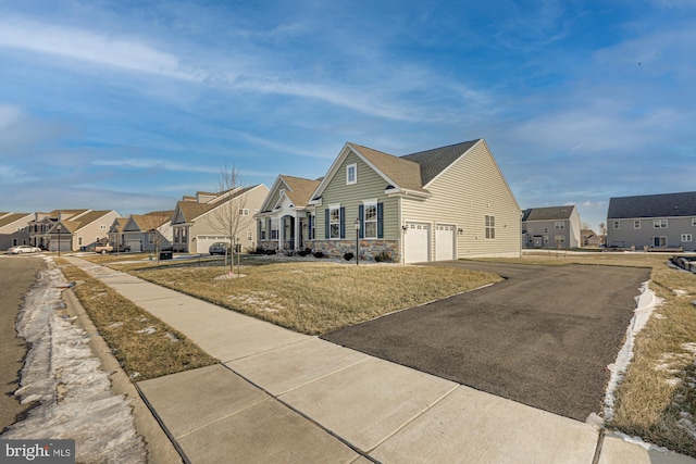 view of side of property with a lawn and a garage