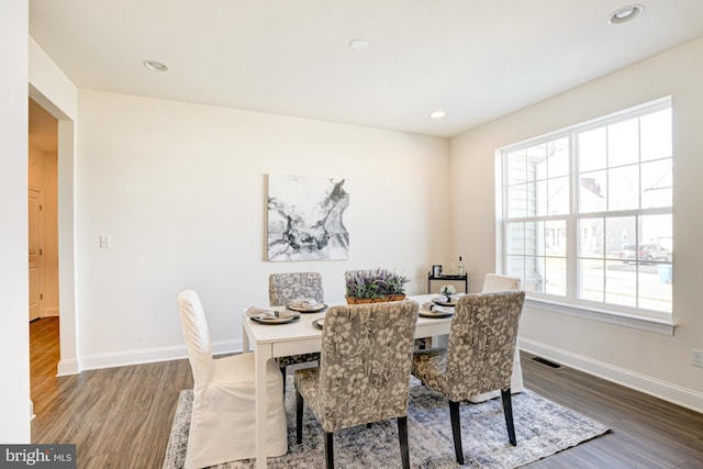 dining space featuring dark hardwood / wood-style flooring