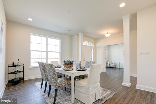 dining area with dark wood-type flooring and decorative columns