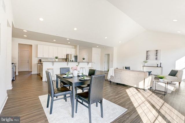 dining area with lofted ceiling and hardwood / wood-style floors